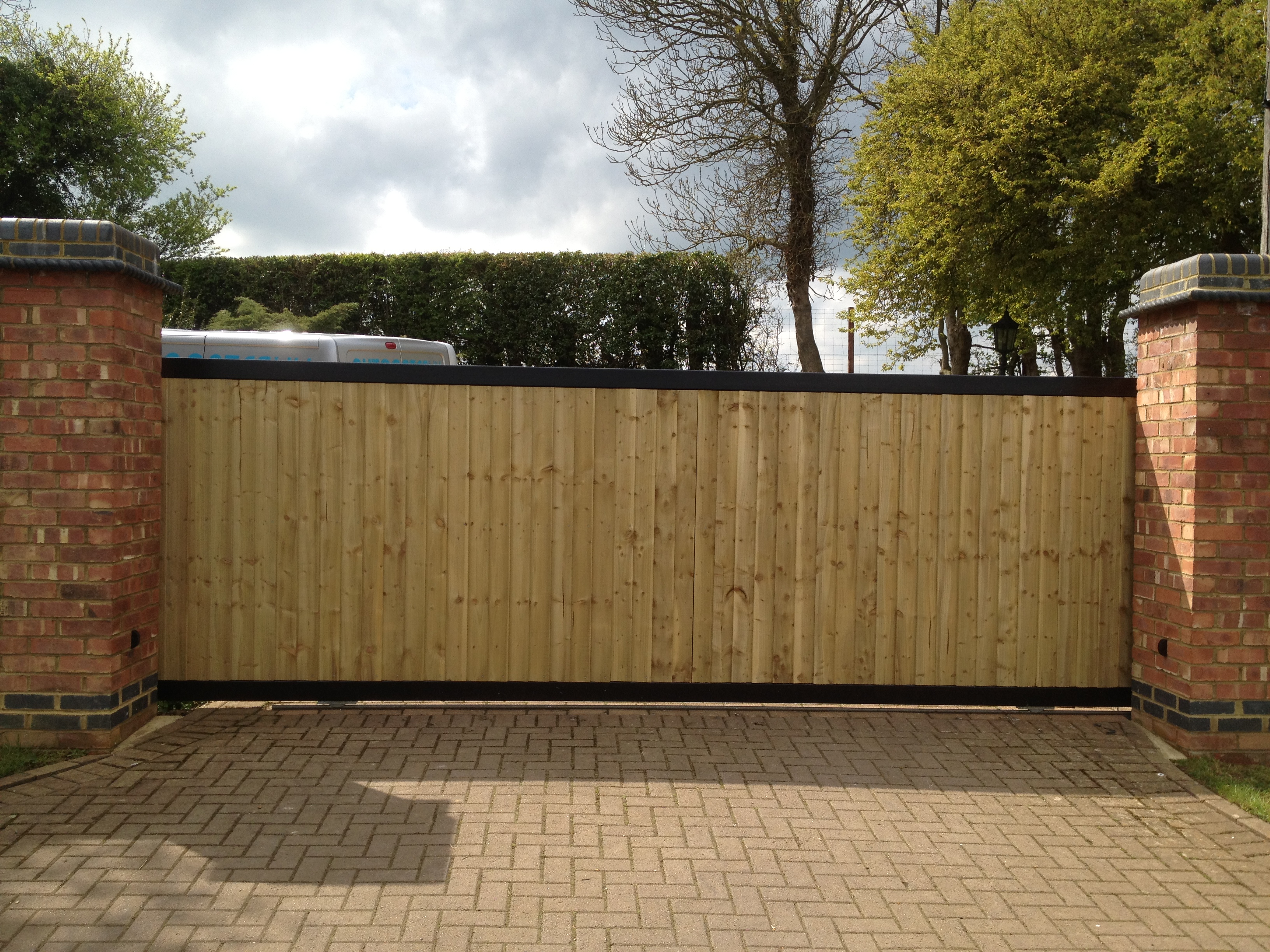 Steel framed tracked sliding gate with a close board fencing infill Front view