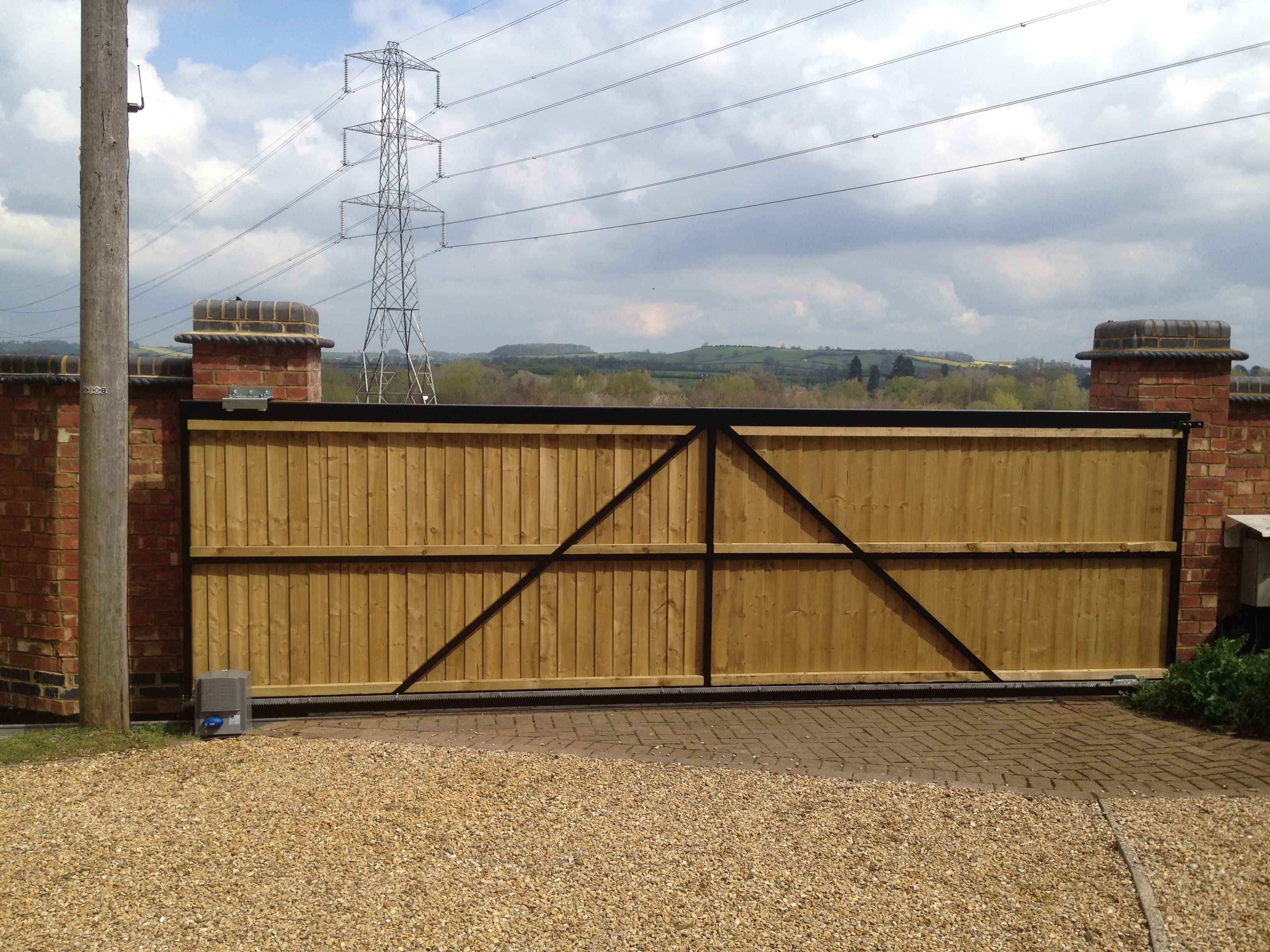 Steel framed tracked sliding gate with a close board fencing infill Rear view