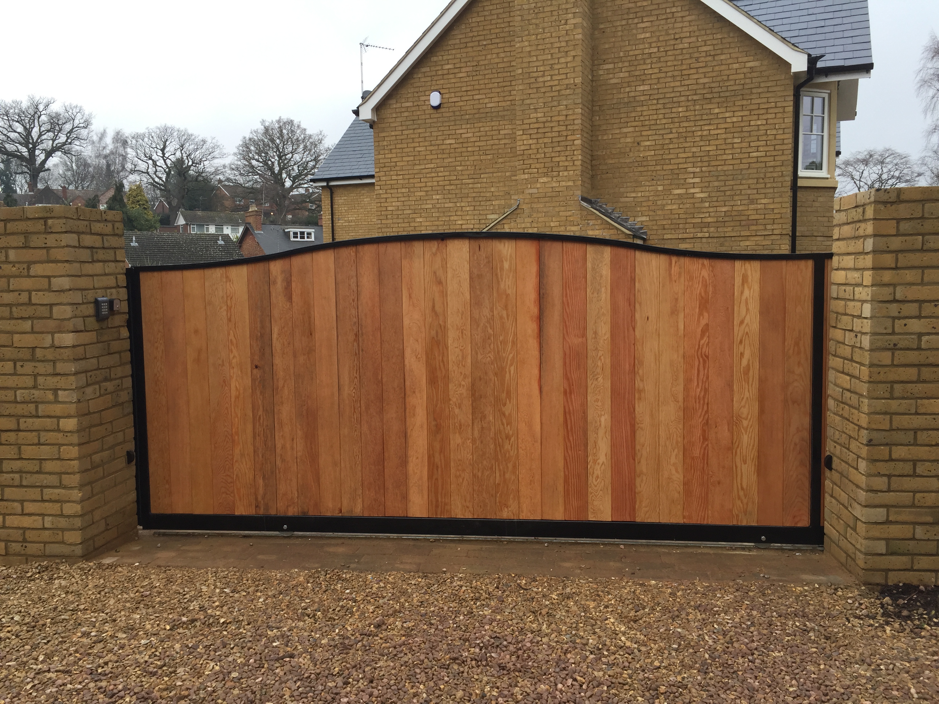 Steel frame tracked sliding gate with T+G infill front
